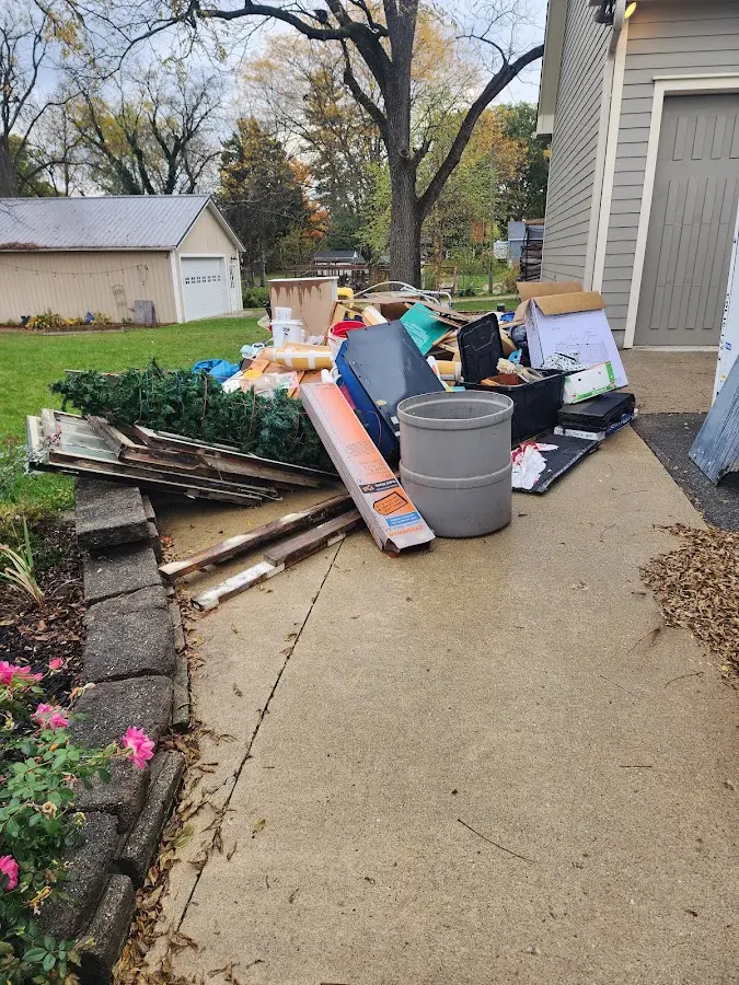 Dumpster being loaded with debris for 12 Yard Dumpster Rental in Syracuse